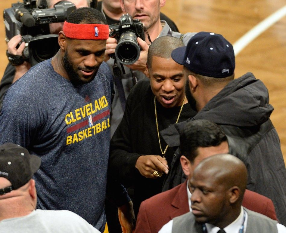 Cleveland Cavaliers forward LeBron James left talks with Jay Z right during the game against the Brooklyn Nets 