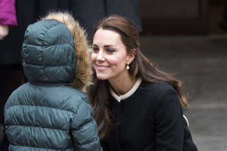Britain's Catherine, Duchess of Cambridge is greeted by a child after an event at the Northside Center for Child Development in the Harlem section of New York, 