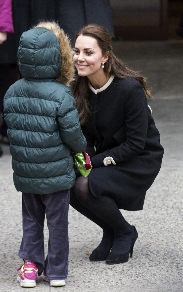 Britain's Catherine, Duchess of Cambridge is greeted by a child after an event at the Northside Center for Child Development in the Harlem section of New York, 