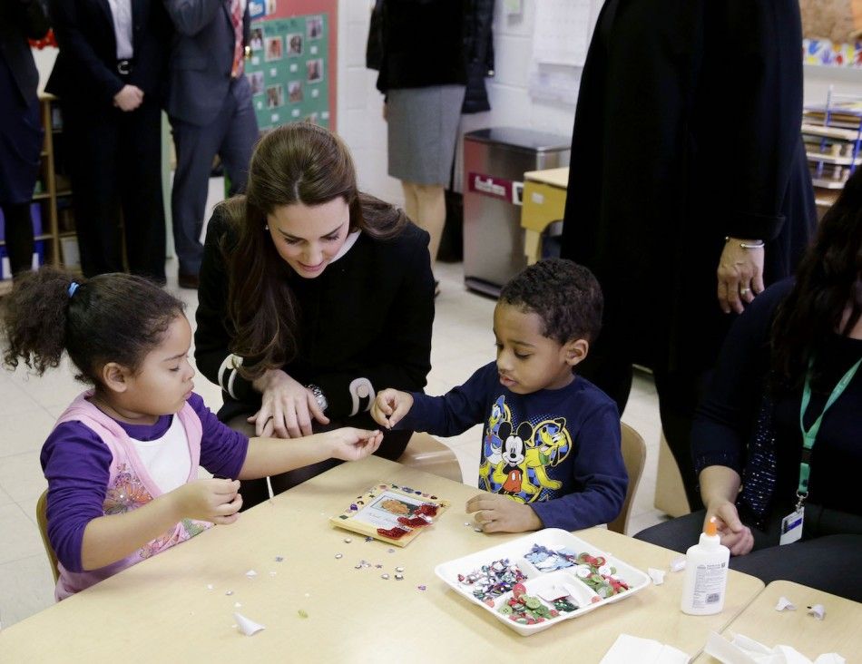 Britains Catherine, Duchess of Cambridge sits next to April, 4, L and Sammy, 4, in a pre-school class at the Northside Center for Childhood Development in New York,