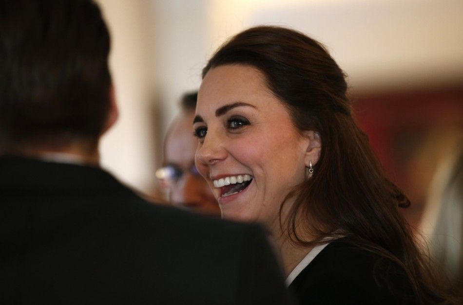Britains Catherine, Duchess of Cambridge laughs as she mingles with members of the British community in New York