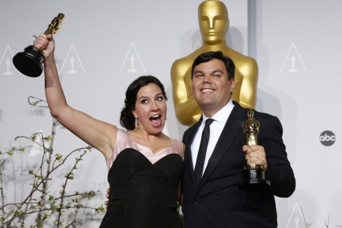 Kristen Anderson-Lopez and Robert Lopez hold their Oscars for best original song for &quot;Let it Go&quot; in the film &quot;Frozen&quot; at the 86th Academy Awards in Hollywood