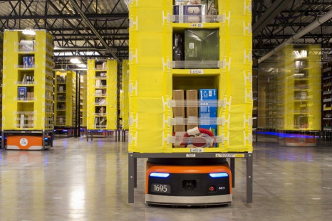Kiva robots move inventory at an Amazon fulfilment center in Tracy, California December 1, 2014. Amazon.com Inc has installed more than 15,000 robots across 10 U.S. warehouses, a move that promises to cut operating costs by one-fifth and get packages out 