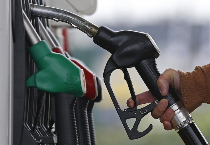 A customer prepares to fill the tank of her car at a fuel station