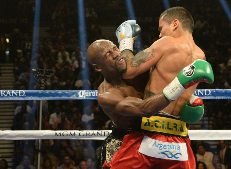 Floyd Mayweather (green gloves) and Marcos Maidana (blue gloves) compete during their WBC & WBA Welterweight and WBC Superwelter Weight title fight at the MGM Grand Garden Arena.