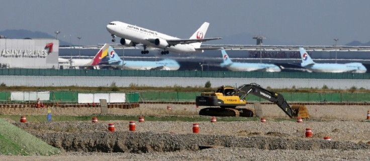 A Japan Airlines airplane takes off during a groundbreaking ceremony for a second terminal of the Incheon Airport in Incheon, west of Seoul September 26, 2013. South Korea's Incheon Airport has begun a $4.6 billion expansion to increase its passenger hand