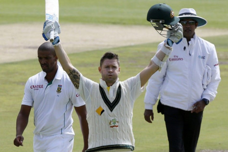 Australia&#039;s Michael Clarke celebrates his century on the second day of their third cricket test match against South Africa in Cape Town, March 2, 2014. At left is South Africa&#039;s Vernon Philander.