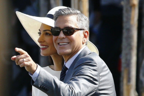 U.S. actor George Clooney and his wife Amal Alamuddin leave Venice city hall after a civil ceremony to formalize their wedding in Venice September 29, 2014.