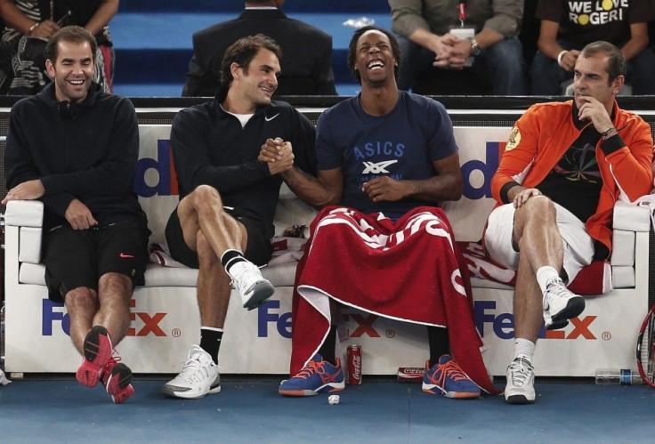 (L-R) Pete Sampras, Roger Federer, Gael Monfils and Cedric Pioline of the Micromax Indian Aces share a moment during their match against the Singapore Slammers at the International Premier Tennis League (IPTL) in New Delhi, December 7, 2014. REUTERS/Adnan