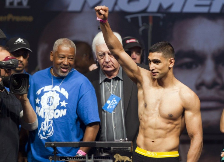 Amir Khan of Britain acknowledges fans during an official weigh-in at the MGM Grand Garden Arena in Las Vegas, Nevada, May 2, 2014. Khan will face Luis Collazo of the U.S. for a welterweight fight at the arena on May 3.