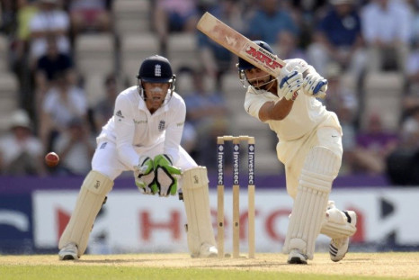 India&#039;s Virat Kohli hits out as England&#039;s Jos Buttler looks on during the third cricket test match at the Rose Bowl cricket ground, Southampton, England July 30, 2014.