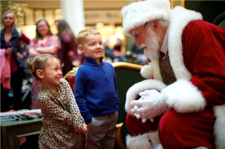 Brayden Knowles, 2, greets Santa Claus, with brother Brynlie, 4, at The Plaza, King of Prussia Mall