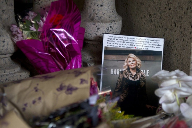 Flowers and a photo, which were left in tribute as part of a makeshift memorial, sit on the steps in front of Joan Rivers&#039; former residence in the Manhattan borough of New York September 6, 2014. Joan Rivers will be laid to rest in a private service 