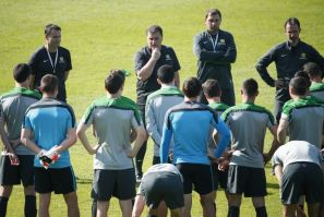 Australian national soccer team Socceroos coach Ange Postecoglou speaks with players during a training session in Sydney