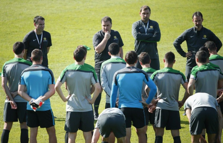 Australian national soccer team Socceroos coach Ange Postecoglou speaks with players during a training session in Sydney