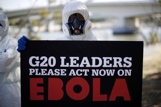 A protester dressed in protective equipment demonstrates, calling for for G20 leaders to address the Ebola issue