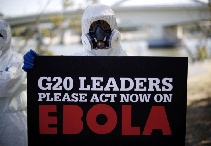 A protester dressed in protective equipment demonstrates, calling for for G20 leaders to address the Ebola issue