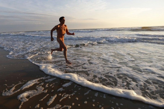 Francois, 48, a French naturist, jogs on the beach at sunset during his holiday at the Centre Helio-Marin (Center for Sun and Sea) naturist campsite on the Atlantic coast in Montalivet, southwestern France, August 12, 2013. The centre, created in July 195