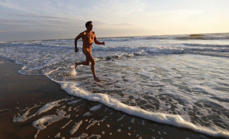 Francois, 48, a French naturist, jogs on the beach at sunset during his holiday at the Centre Helio-Marin (Center for Sun and Sea) naturist campsite on the Atlantic coast in Montalivet, southwestern France, August 12, 2013. The centre, created in July 195