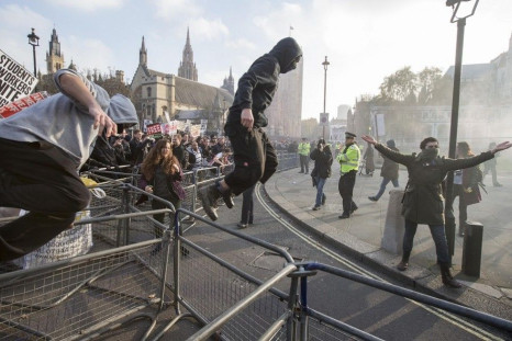Demonstrators break through barricades in Parliament Square in front of the Houses of Parliament, as they participate in a protest against student loans and in favour of free education, in central London November 19, 2014.
