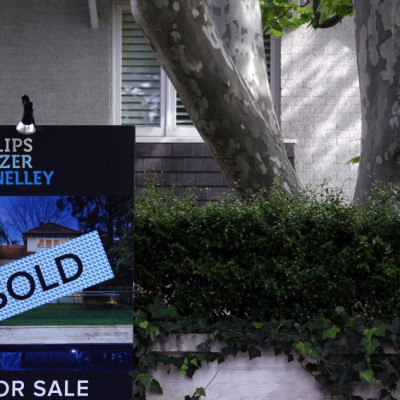 A real estate agent's sign outside a house shows that it has recently been sold in Sydney