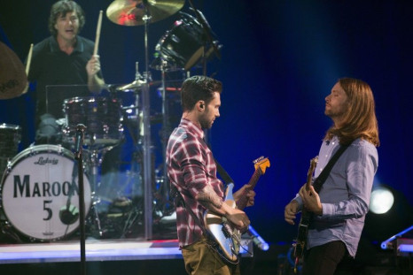 Vocalist Adam Levine (C), guitarist James Valentine (R) and drummer Matt Flynn of pop rock band Maroon 5 perform during the band's album release party for &quot;V&quot; at the iHeartRadio theatre in Burbank, California August 26, 2014.
