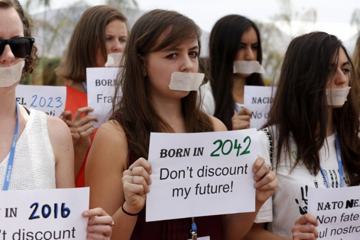 Participants of the UN Climate Change Conference COP 20 and members of YOUNGO group, with their mouths taped, take part in a protest demanding reduction in fossil fuel emissions by 2050, at the conference venue in Lima December 4, 2014. The two-week long 