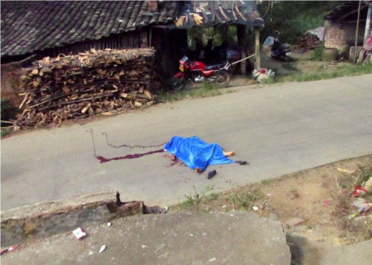 The body of a child is pictured on a road leading to a primary school in Lingshan county