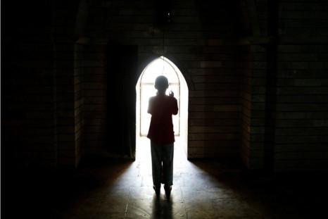 A displaced girl from the minority Yazidi sect, who fled violence in the Iraqi town of Sinjar, worships at their main holy temple Lalish in Shikhan