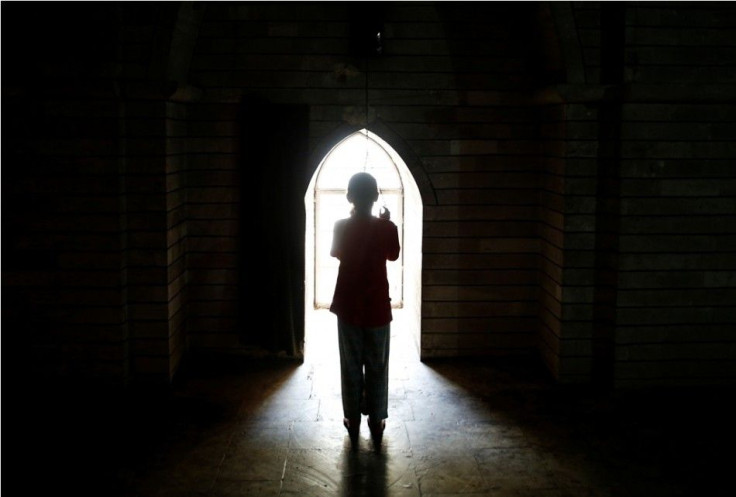 A displaced girl from the minority Yazidi sect, who fled violence in the Iraqi town of Sinjar, worships at their main holy temple Lalish in Shikhan