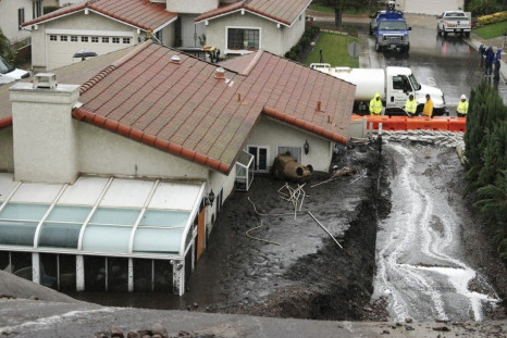 Crews work to channel mudflows in the area of the 2013 Springs Fire, in Camarillo, California December 2, 2014. The area is under mandatory evacuation as a powerful winter storm brings heavy rain to southern California burn areas in Ventura, Los Angeles, 