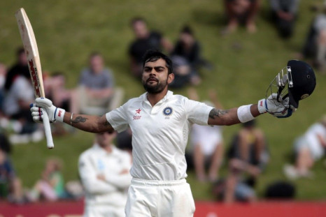 India&#039;s Virat Kohli acknowledges his 100 against New Zealand during the second innings of play on day five of the second international test cricket match at the Basin Reserve in Wellington, February 18, 2014.