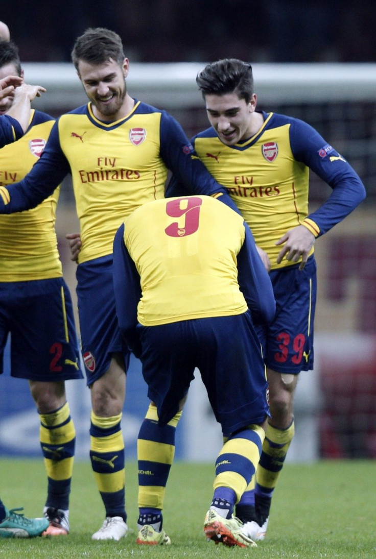 Arsenal&#039;s Aaron Ramsey (L) haves his boot kissed by team mate Lukas Podolski (C) as he celebrates his second goal against Galatasaray during their Champions League Group D soccer match at Ali Sami Yen Spor Kompleksi in Istanbul December 9, 2014.