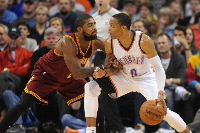 Dec 11, 2014; Oklahoma City, OK, USA; Oklahoma City Thunder guard Russell Westbrook (0) handles the ball against Cleveland Cavaliers guard Kyrie Irving (2) during the second quarter at Chesapeake Energy Arena.