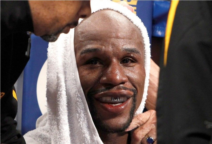 WBC/WBA welterweight champion Floyd Mayweather Jr. sits in his corner between rounds