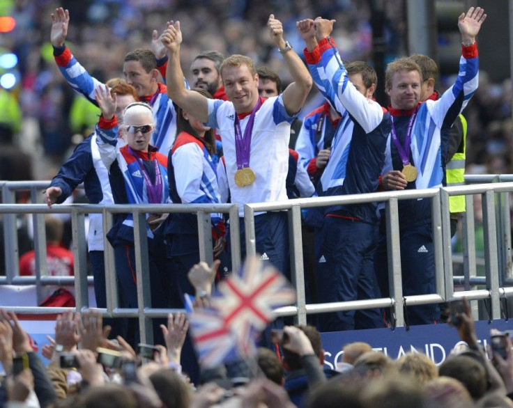 Double gold medalist Sir Chris Hoy gestures to the crowds during Scotland&#039;s Olympians and Paralympians parade in Buchanan St Glasgow as part of their homecoming celebrations, September 14, 2012.