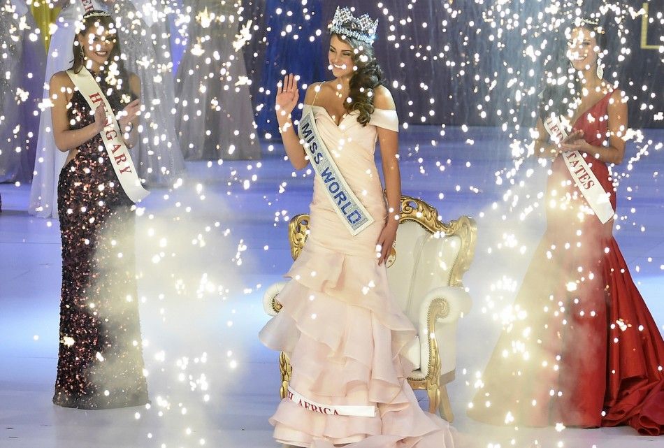 Rolene Strauss of South Africa C is crowned Miss World 2014 by Miss World 2013, Megan Young of the Philippines C rear, as Elizabeth Safrit of the U.S R and Edina Kulczar of Hungary L who placed third and second respectively