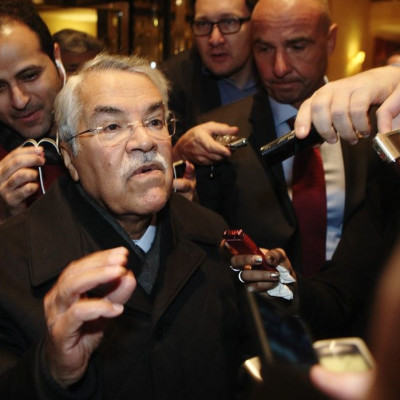 Saudi Arabian Oil Minister Ali al-Naimi gestures as he arrives at his hotel ahead of an OPEC meeting