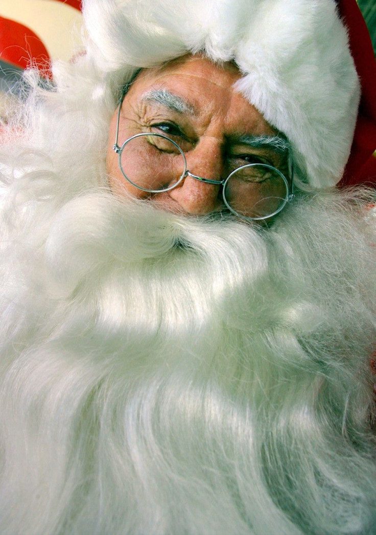 A man dressed as Santa Claus smiles after disembarking a Qantas plane, that allegedly came from the North Pole, for a charity event in Sydney November 9, 2005. The man is part of a group of 45 Santas that has recently been through a training course on how