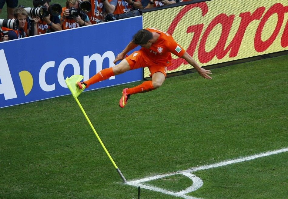 Klaas-Jan Huntelaar of the Netherlands kicks a corner flag to celebrate after scoring a goal during the 2014 World Cup round of 16 game between Mexico and the Netherlands at the Castelao arena in Fortaleza June 29, 2014. 