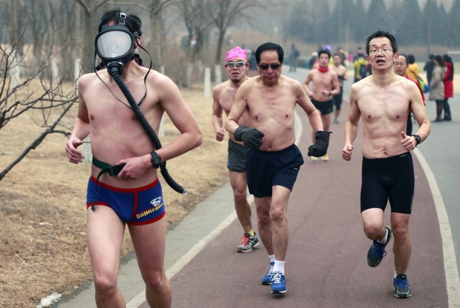 A half-naked participant wears a gas mask as he takes part in the quotGuangzhu naked Runquot with others on a hazy winter morning at the Olympic Forest Park in Beijing, February 23, 2014. Beijings running enthusiasts joined this event, which requir