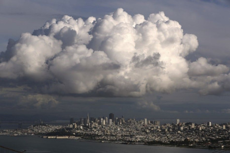 A large cloud gathers over the skyline of San Francisco, California December 12, 2014. A major storm pummeled California and the Pacific Northwest with heavy rain and high winds on Thursday, killing one man, knocking out power to tens of thousands of home