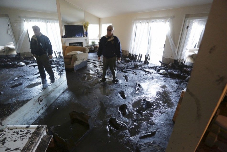 Homeowner Elton Gallegly walks through his home after a mud slide came down on at least 8 homes during heavy rains in Camarillo Springs, California, December 12, 2014. A majorstorm that pummeled northern California and the Pacific Northwest with heavy rai