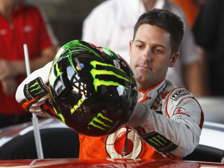 Driver Jamie Whincup from Team Australia holds up his helmet ahead of practice for the Race of Champions (ROC) at the Rajamangala National Stadium in Bangkok December 16, 2012. The Race of Champions runs from December 14 to 16.