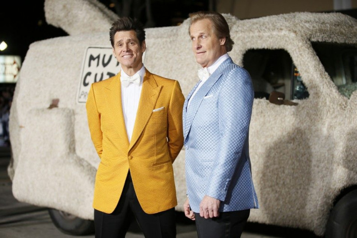 Actors Jim Carrey (L) and Jeff Daniels arrive in a van decorated as a dog at the world premiere of the film &quot;Dumb and Dumber To&quot; in Los Angeles, November 3, 2014.