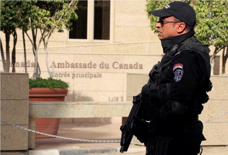 An armed police officer is deployed in front of the Canadian embassy in Cairo