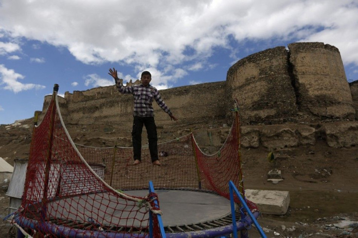 An Afghan boy plays on a trampoline in Kabul March 24, 2014. REUTERS/Mohammad Ismail