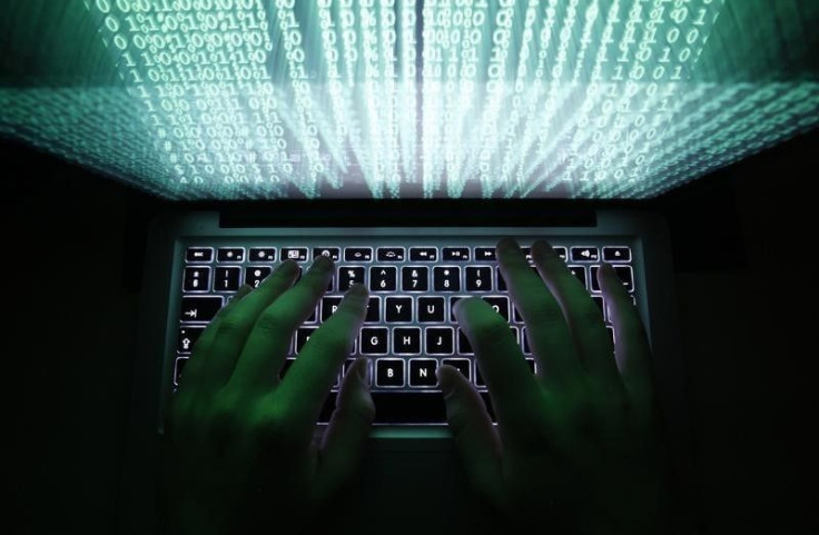 A man types on a computer keyboard in Warsaw