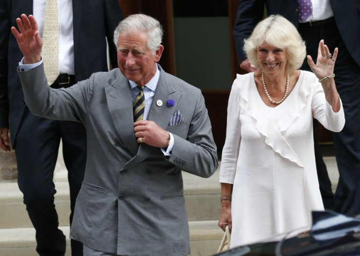 Britain's Prince Charles and his wife Camilla, Duchess of Cornwall leave the Lindo Wing of St Mary's Hospital the day after Catherine, Duchess of Cambridge, gave birth to a baby boy, in London July 23, 2013.