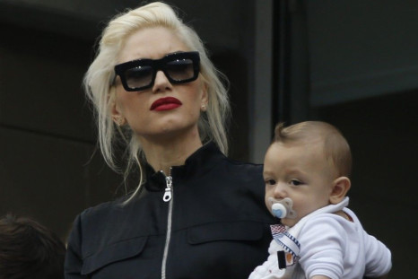 Singer Gwen Stefani holds her son Apollo as she attends the semi-final match between Marin Cilic of Croatia and Roger Federer of Switzerland at the 2014 U.S. Open tennis tournament in New York, September 6, 2014.